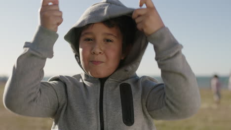 portrait-of-happy-hispanic-boy-playing-making-faces-funny-silly-enjoying-sunny-day-at-seaside-park