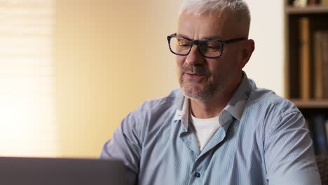 Man Using Laptop at Home