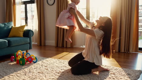 mother and baby playing happily at home
