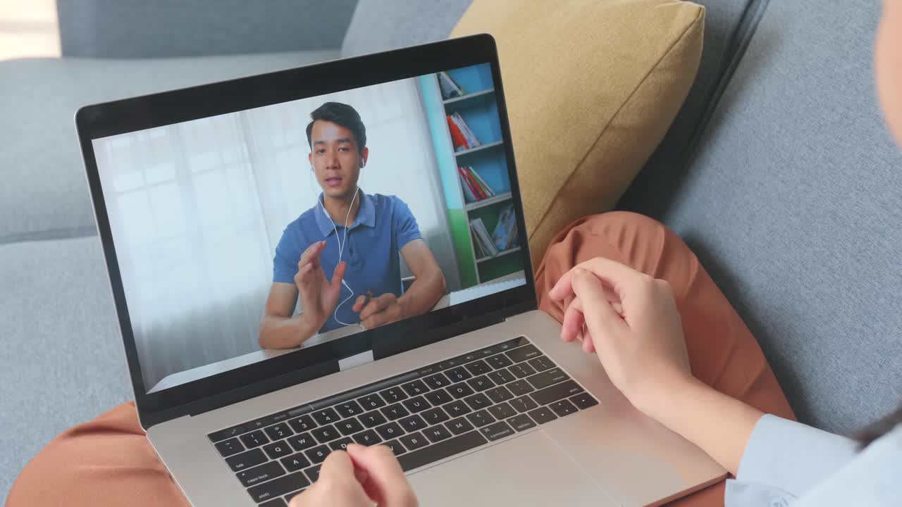 Woman Greeting With Colleagues In Video Conference Call From Laptop At Living Room, Video In 4K