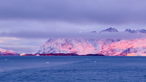 sun rising on the mountains in east greenland