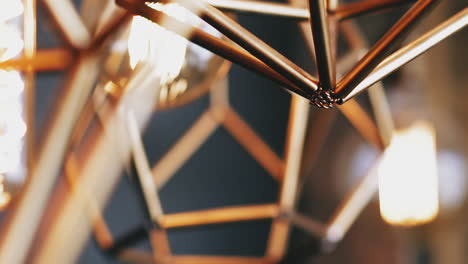 steam-punk luster and light bulb hang on ceiling in room