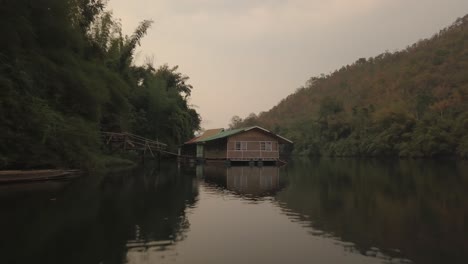 aerial view of scenic landscape of thailand countryside, houses on river in twilight before sunrise