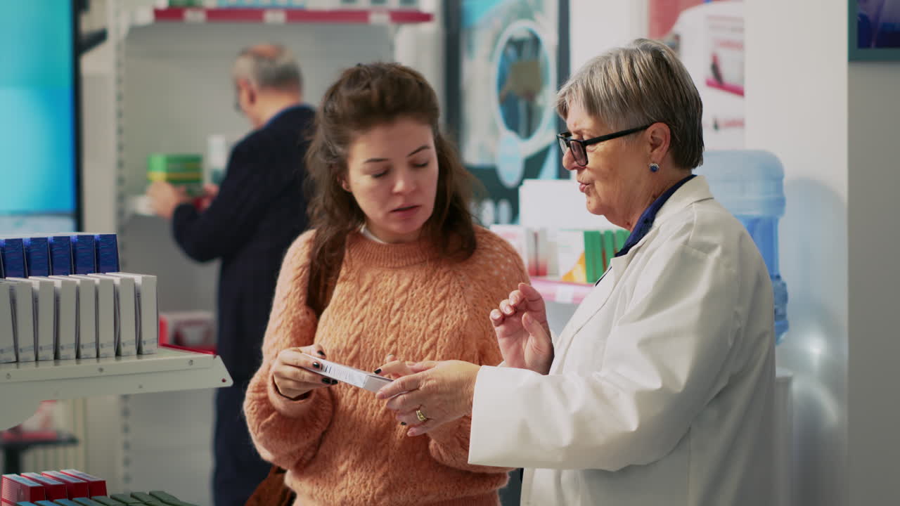 Pharmacist assisting customer with medication in a pharmacy