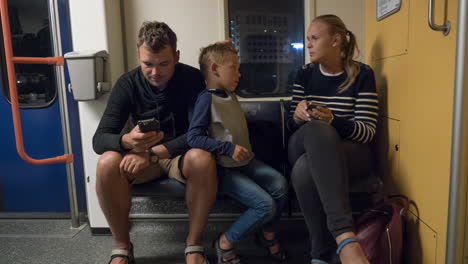 timelapse of parents with son in underground train