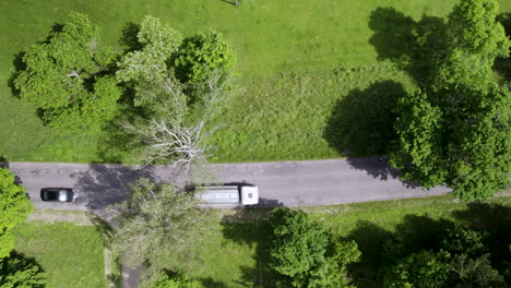 car and truck driving on countryside asphalt road