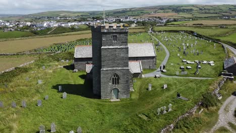 rising shot of the front of st materiana's church in tintagel, cornwall early in the morning just before the tourists arive to look around this beautiful landmark overlooking the sea and cliffs