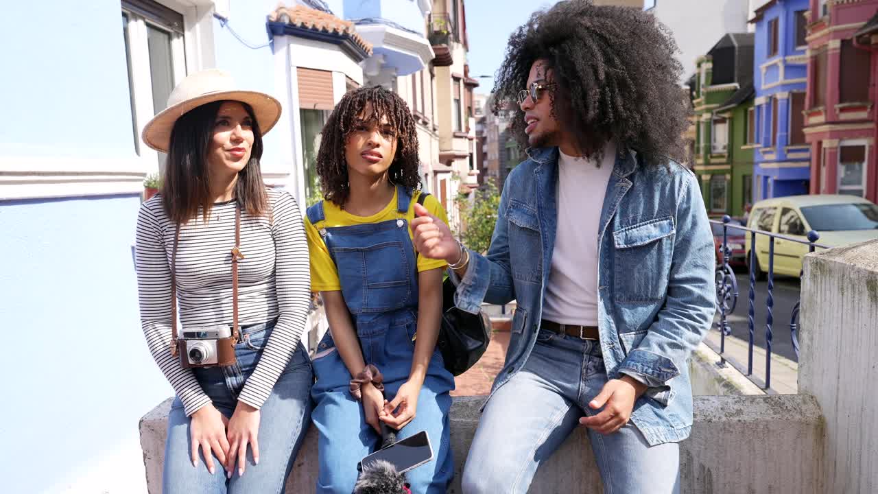Three friends hanging out on a street