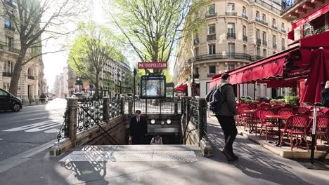 a man walks across a bridge in paris, carrying a bag.