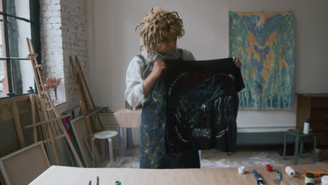 Artist-showing-his-art-in-an-art-studio