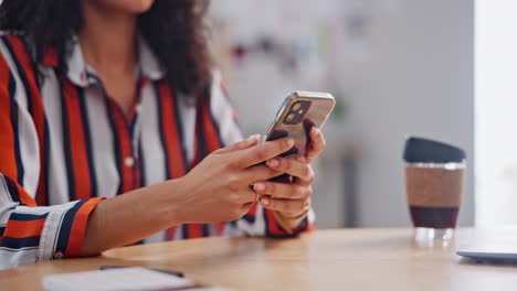 mujer usando un teléfono inteligente en una mesa