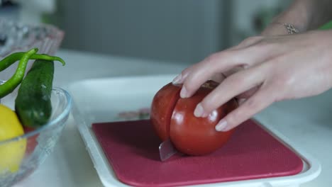 cutting tomatoes on pink chopping board