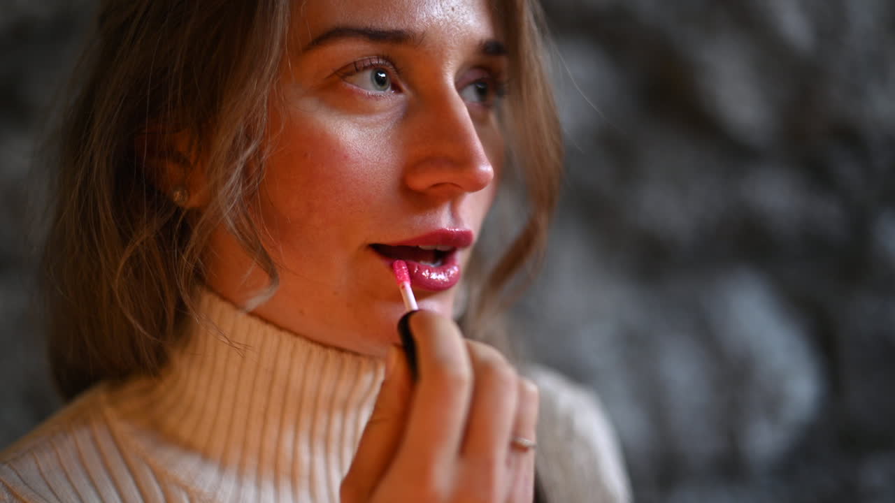 Woman applying red lipstick in a restaurant