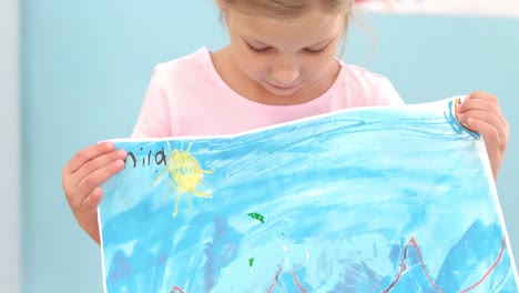 happy girl showing her painting