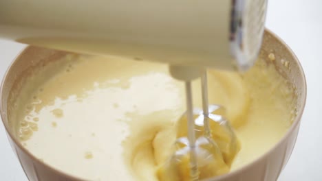 close-up of a mixer whipping a batter