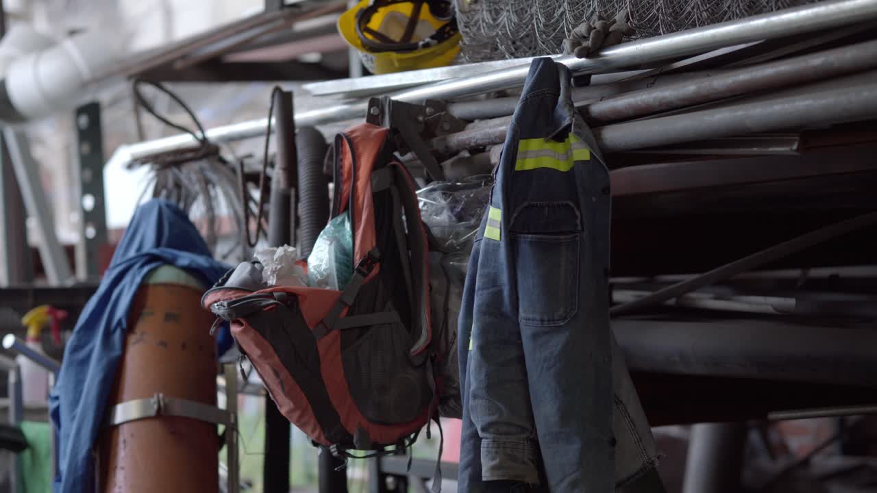 Work gear hanging in industrial space, reflecting a day at the workshop