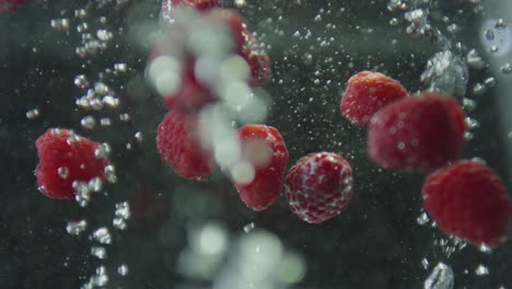 raspberries falling into boiling water with bubbles