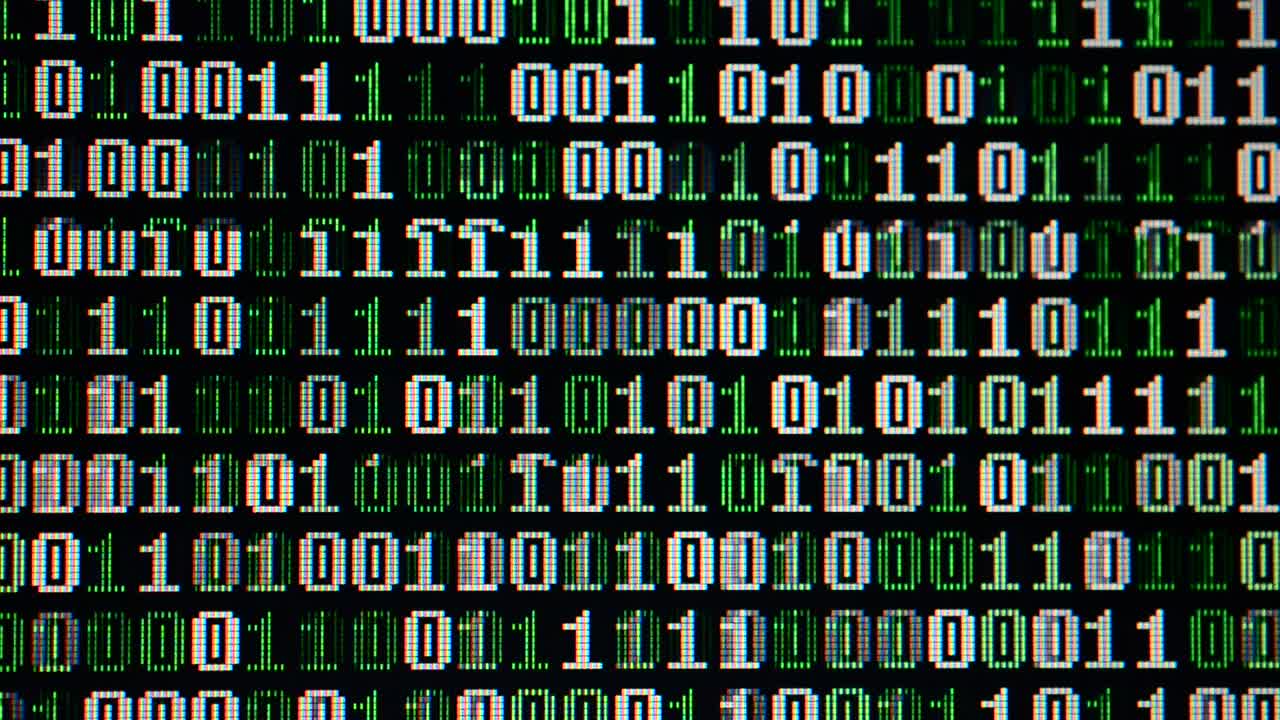 Binary code on the monitor screen. Shooting of a binary code, background