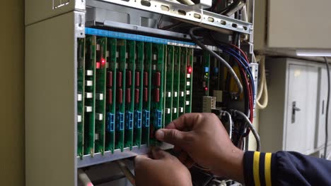 technician or engineer changes the motherboard, pbx, telephone with flashing lights indicating the digital system connection