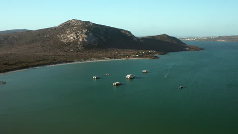 Beautiful-Turquoise-Sea-With-Boats-In-West-Coast-National-Park,-South-Africa---aerial-drone-shot