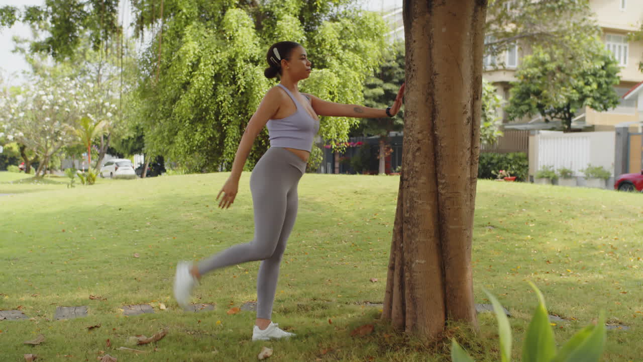 Latin Girl Stretching Ankles Muscles in Park