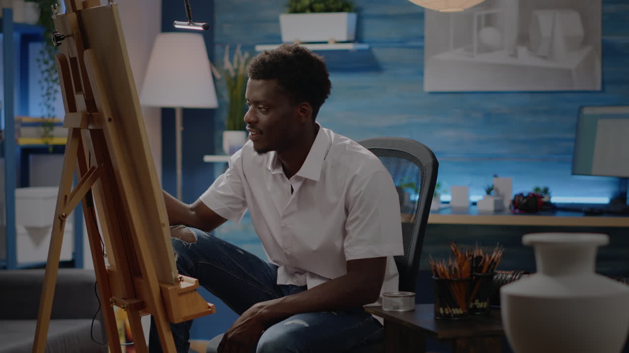 Young afro artist drawing using inspiration from vase design