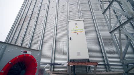 big factory cistern exterior construction. huge modern elevator premises with big ventilators. circle view with approximation to a locker with buttons.