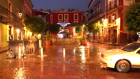 nighttime rainy street scene in guanajuato, mexico