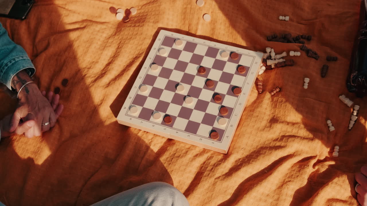 Friends Playing Checkers at a Picnic