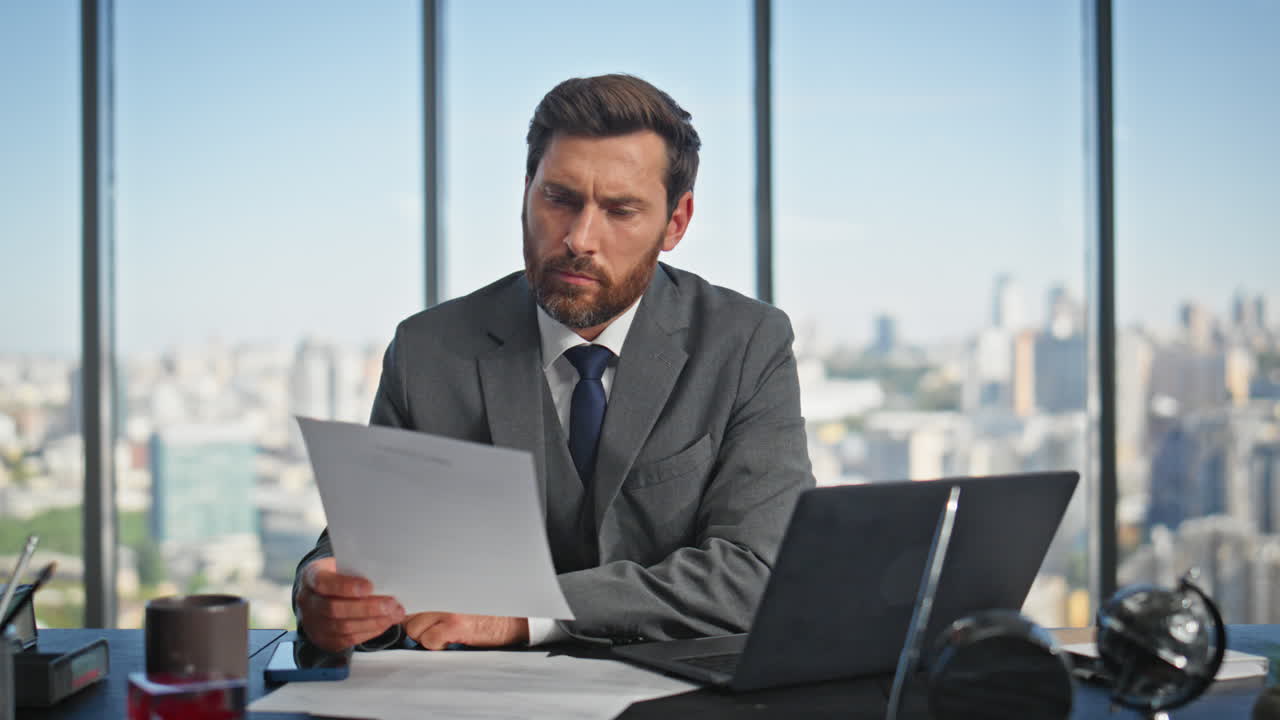 Successful manager working desk browsing computer. Pensive man reading ...
