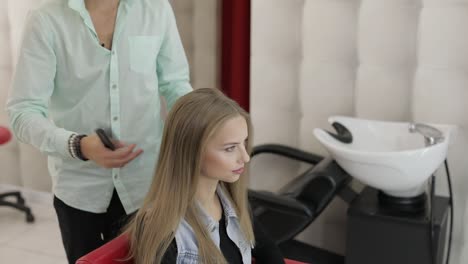 a woman having her hair styled at a salon