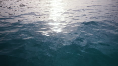 crystal clear blue sea surface at sunset with golden hour light in the indian ocean