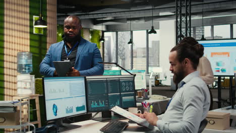 vertical video african american office worker uses tablet to examine business resources