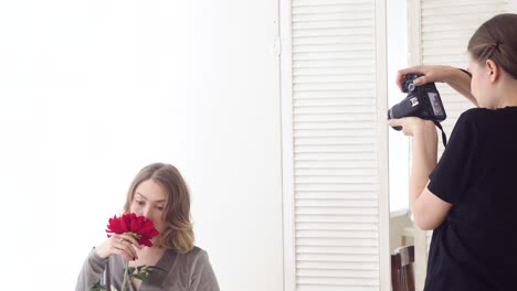 woman taking a photo of a flower