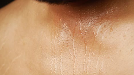 close up of sweat dripping down a person's neck