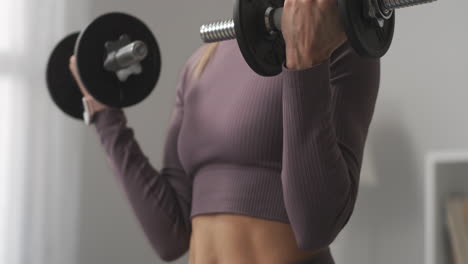 mujer deportiva está levantando pesas entrenando los músculos de las manos y el pecho vista detallada del cuerpo actividad deportiva y estilo de vida saludable mantenerse en forma para las mujeres