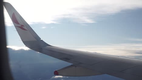 view-of-the-wing-of-a-commercial-airplane-from-the-window-with-clear-sky