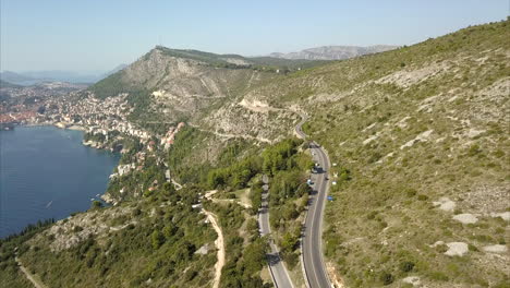 aerial shot of dubrovnik hills and roads with old town in the distance