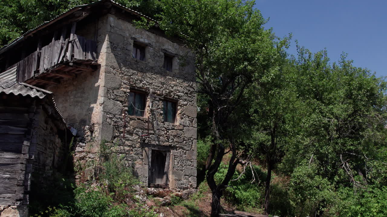 An old stone building surrounded by trees
