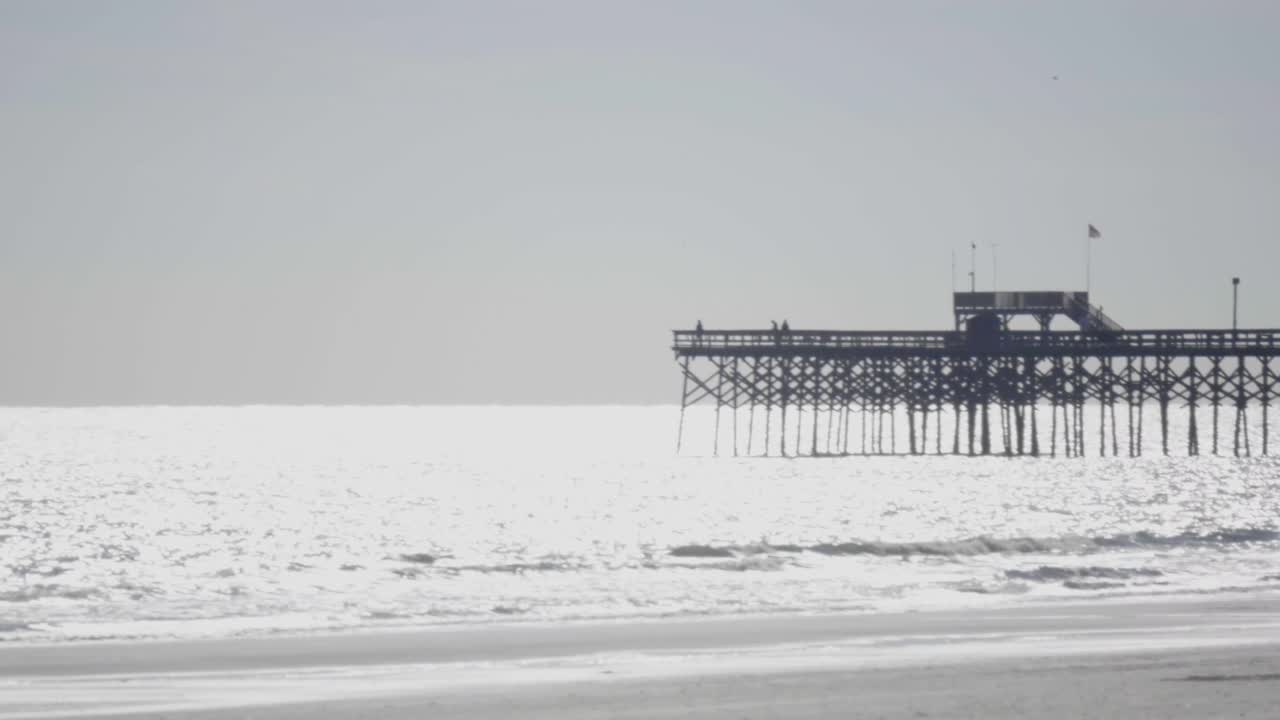 Pier stretching out into the ocean.