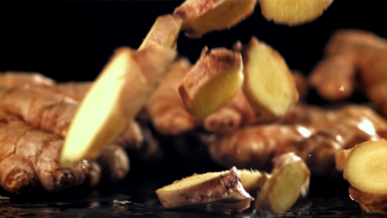 Fresh Ginger Slices Falling in Slow Motion
