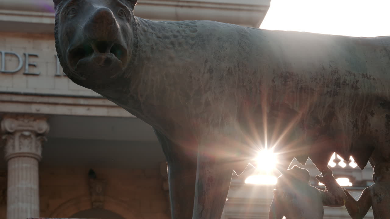 Chisinau, Moldova - September 25, 2025: Historic bronze statue of the Capitoline Wolf with Romulus and Remus on a red marble pedestal in front of the National History Museum of Moldova
