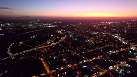 City-of-Temuco,-Chile,-Aerial-View-Above-Cityscape-of-Cautin-Province-at-Night,-Sunset-Horizon,-Houses-and-Streets-of-the-Chilean-Town