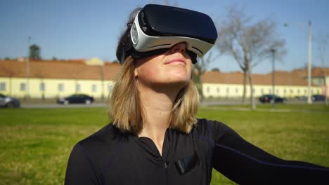 chica deportiva feliz usando auriculares de realidad virtual al aire libre