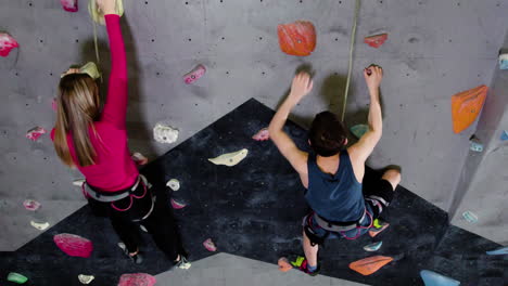 teenage boy and girl climbing indoors