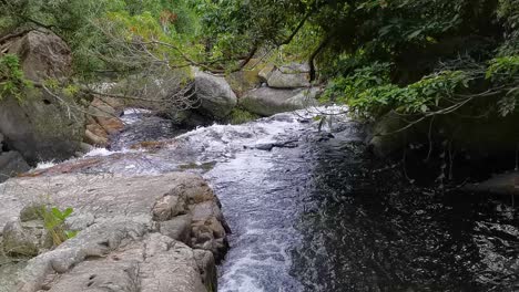 flowing water from waterfall at little hawaii trail, tseung kwan o, hong kong