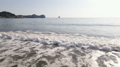 A-small-wave-crashing-onto-the-shore-of-at-Quepos-beach-during-sunset