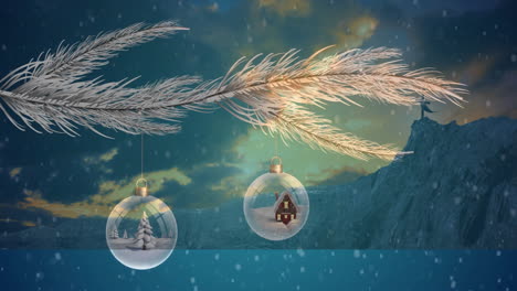 hanging from frosted branches, christmas ornaments with winter scenes in snowy landscape