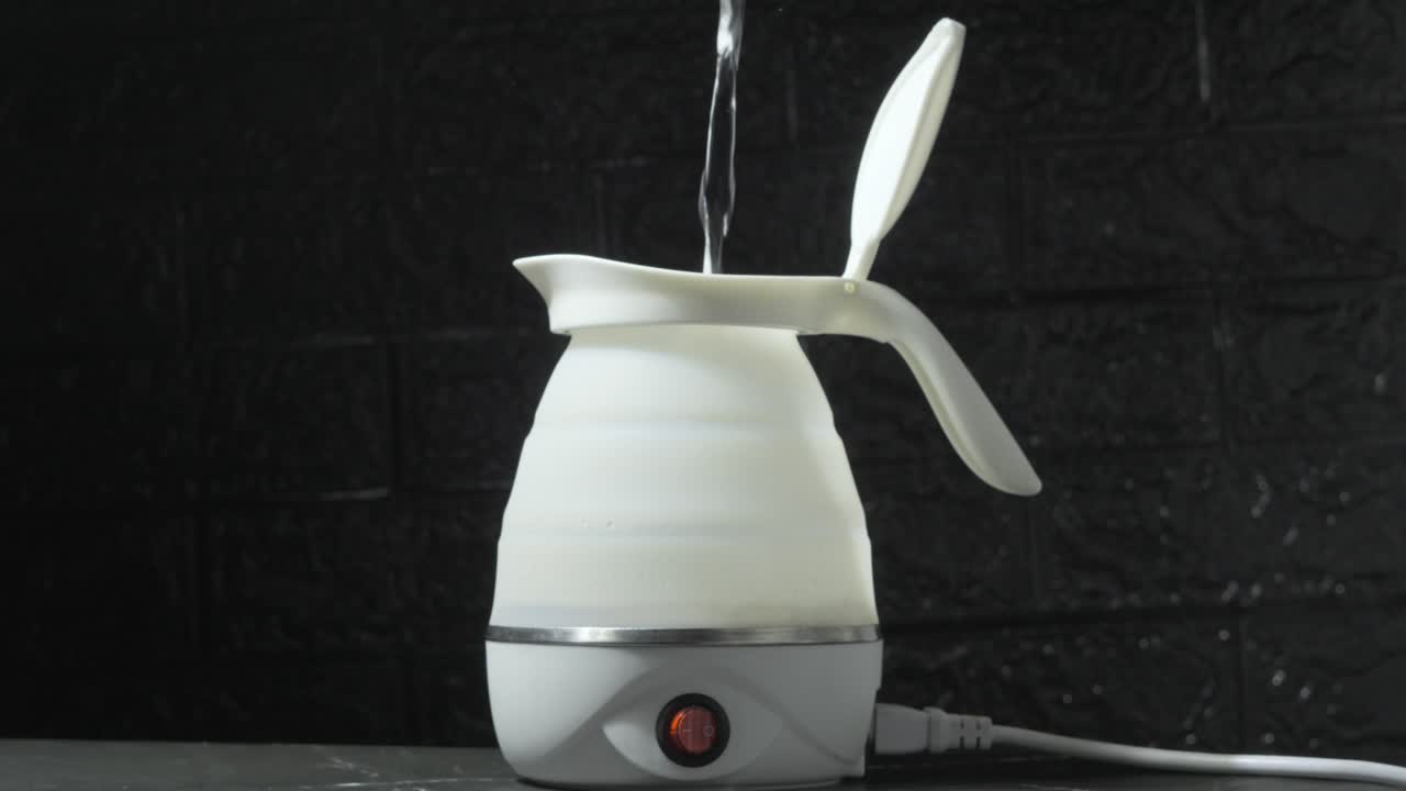 pouring water in silicone foldable electric kettle