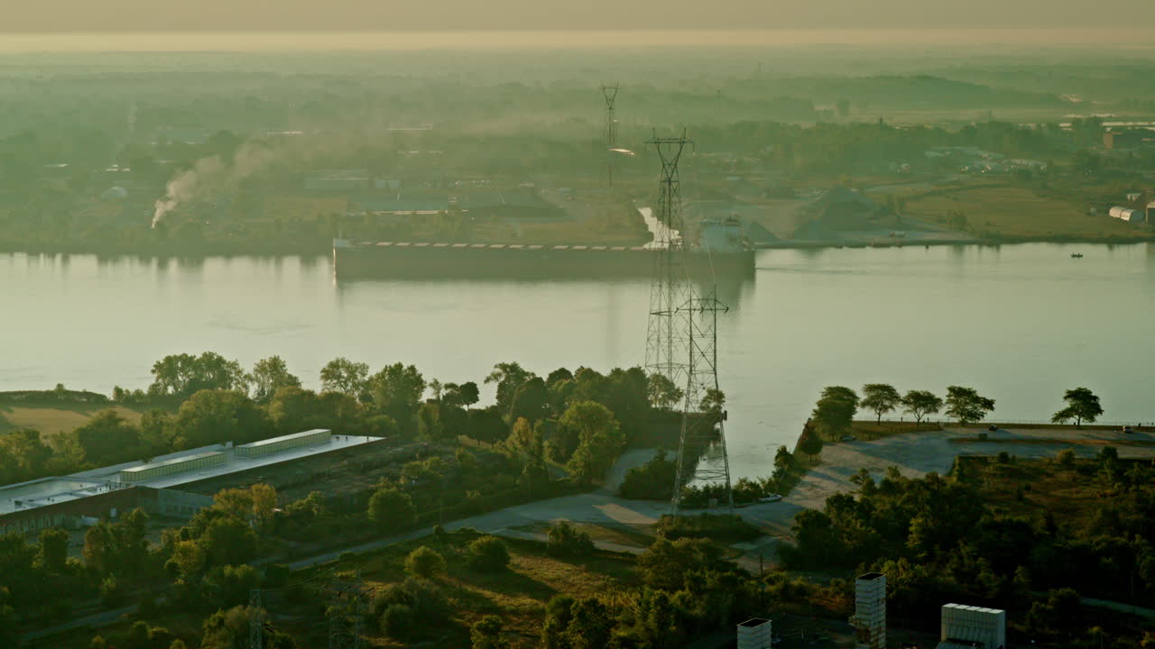 Elevated drone view of a freighter cruising the Detroit River with the bridge in the distance